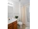 Bathroom with a wooden vanity, sink and a bathtub with shower curtain at 4014 Santa Maria Dr # 101, Kissimmee, FL 34741
