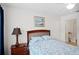 Bedroom features a ceiling fan, standard window with a blue patterned bedspread and matching decor at 4014 Santa Maria Dr # 101, Kissimmee, FL 34741