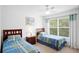 Bedroom features standard windows, ceiling fan, and twin beds with a blue patterned bedspread at 4014 Santa Maria Dr # 101, Kissimmee, FL 34741