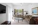 Inviting living room featuring neutral tones, a ceiling fan, and large window for natural lighting at 4014 Santa Maria Dr # 101, Kissimmee, FL 34741