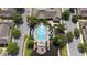 An aerial view of the community pool with lounge chairs and umbrellas at 4014 Santa Maria Dr # 101, Kissimmee, FL 34741