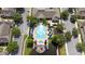 Aerial view of a community pool surrounded by seating and lush landscaping at 4014 Santa Maria Dr # 101, Kissimmee, FL 34741