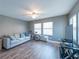 Spacious living room with neutral decor, hardwood floors, and abundant natural light at 405 Eron Way # 39, Winter Garden, FL 34787