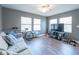 Comfortable living room with hardwood floors, modern gray paint and lots of natural light at 405 Eron Way # 39, Winter Garden, FL 34787