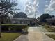 Charming single-story home featuring a well-maintained front yard with mature trees and a driveway at 4339 Solomon Dr, Orlando, FL 32811