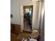 Hallway with a view into a cluttered adjacent room, showcasing transition space at 4339 Solomon Dr, Orlando, FL 32811