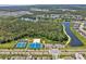 An aerial view of community amenities including a lake, tennis courts, sports fields, and playgrounds at 4492 Bluff Oak Loop, Kissimmee, FL 34746