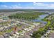 Overhead view of neighborhood homes and a serene lake, depicting a peaceful community at 4492 Bluff Oak Loop, Kissimmee, FL 34746