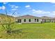 Expansive backyard featuring a lush lawn, perfect for outdoor activities and entertaining, with patio at 4492 Bluff Oak Loop, Kissimmee, FL 34746