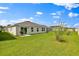 Spacious backyard with a well-maintained lawn, ideal for gatherings and relaxation, showcasing a patio at 4492 Bluff Oak Loop, Kissimmee, FL 34746