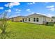 Large backyard displaying a verdant lawn, offering ample space for recreation, along with a patio at 4492 Bluff Oak Loop, Kissimmee, FL 34746