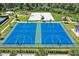 Aerial view of blue basketball courts, recreational areas, and green landscaping in community park at 4492 Bluff Oak Loop, Kissimmee, FL 34746