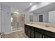 Dual sinks, granite countertops, and a glass-enclosed shower provide a spa-like experience at 4492 Bluff Oak Loop, Kissimmee, FL 34746