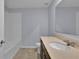 The bathroom offers a vanity sink and a shower-tub with white tile surround at 4492 Bluff Oak Loop, Kissimmee, FL 34746
