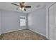 Cozy bedroom features carpet, ceiling fan, and a window allowing natural light at 4492 Bluff Oak Loop, Kissimmee, FL 34746