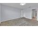 Neutral walls, carpet, and an open door lead to another bedroom and bathroom at 4492 Bluff Oak Loop, Kissimmee, FL 34746