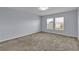An unfurnished bedroom offers natural light and carpeting at 4492 Bluff Oak Loop, Kissimmee, FL 34746