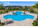 A resort-style community pool with ample seating, palm trees, and inviting blue water at 4492 Bluff Oak Loop, Kissimmee, FL 34746