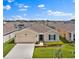 One-story home features a well-kept lawn and driveway nestled in a community with a beautiful blue sky backdrop at 4492 Bluff Oak Loop, Kissimmee, FL 34746