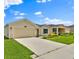 Well-maintained one-story home with a spacious driveway and lush green lawn in a peaceful neighborhood at 4492 Bluff Oak Loop, Kissimmee, FL 34746