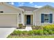 Close-up of the home's entrance, highlighting the stylish front door, trim, and well-kept landscaping at 4492 Bluff Oak Loop, Kissimmee, FL 34746