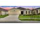 Charming single-story home featuring a manicured lawn and a two-car garage with great curb appeal at 4492 Bluff Oak Loop, Kissimmee, FL 34746