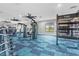 Well-equipped gym with modern exercise machines and equipment, plus a full window for outside views at 4492 Bluff Oak Loop, Kissimmee, FL 34746