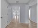 Bright hallway features tile flooring and neutral paint, leading to various rooms of the home at 4492 Bluff Oak Loop, Kissimmee, FL 34746