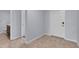 Hallway featuring tile flooring, bathroom, and a front entrance door for a practical living space at 4492 Bluff Oak Loop, Kissimmee, FL 34746