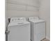 Functional laundry room equipped with a washer, dryer, and overhead shelving for storage at 4492 Bluff Oak Loop, Kissimmee, FL 34746