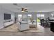 Open-concept living room boasts stylish decor, neutral paint, and sliding door access to the backyard at 4492 Bluff Oak Loop, Kissimmee, FL 34746