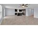 Expansive living area showcases tile flooring and flows into the kitchen with stainless appliances and dark cabinets at 4492 Bluff Oak Loop, Kissimmee, FL 34746