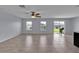 Spacious living room features a ceiling fan, large windows, and an open layout to the backyard at 4492 Bluff Oak Loop, Kissimmee, FL 34746