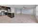 Open living space includes tile flooring and a kitchen area with dark cabinetry and stainless steel appliances at 4492 Bluff Oak Loop, Kissimmee, FL 34746