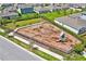 A fenced community playground with swings, slide, climbing structures and benches for fun and relaxation at 4492 Bluff Oak Loop, Kissimmee, FL 34746