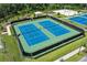 Aerial view showcasing two tennis courts enclosed with a black fence in a community setting at 4492 Bluff Oak Loop, Kissimmee, FL 34746