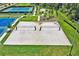 Aerial view of a sand volleyball court surrounded by green grass and recreational facilities at 4492 Bluff Oak Loop, Kissimmee, FL 34746