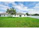 Spacious backyard with green grass, a privacy fence, and a view of the house at 4613 Madison Ave, Lake Wales, FL 33859