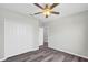 Bedroom with modern ceiling fan, wood-look floors, and spacious closet at 4613 Madison Ave, Lake Wales, FL 33859