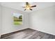 Bright bedroom features a ceiling fan, wood-look floors, and a window providing natural light at 4613 Madison Ave, Lake Wales, FL 33859