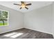 Bedroom with hardwood floors, a ceiling fan and a sunlit window at 4613 Madison Ave, Lake Wales, FL 33859