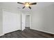 Bedroom with modern ceiling fan, wood-look floors, and spacious closet at 4613 Madison Ave, Lake Wales, FL 33859