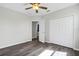 Bedroom with modern ceiling fan, wood-look floors, and spacious closet at 4613 Madison Ave, Lake Wales, FL 33859