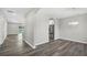 Dining area featuring wood floors and a modern chandelier, with view into kitchen at 4613 Madison Ave, Lake Wales, FL 33859