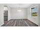 Dining area with wood floors, stainless steel fridge and view of the outdoors at 4613 Madison Ave, Lake Wales, FL 33859