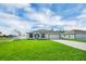 Inviting single-story home with lush green lawn, long driveway, and a two car garage at 4613 Madison Ave, Lake Wales, FL 33859