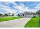 Beautiful single-story home featuring a lush green lawn and long driveway at 4613 Madison Ave, Lake Wales, FL 33859