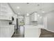 A modern kitchen boasts white cabinets, quartz countertops, and stainless steel appliances at 4613 Madison Ave, Lake Wales, FL 33859