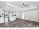 A modern open-concept kitchen features white cabinets and flows into the living area at 4613 Madison Ave, Lake Wales, FL 33859
