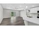 Open living space with wood floors, a ceiling fan, and a sliding glass door at 4613 Madison Ave, Lake Wales, FL 33859